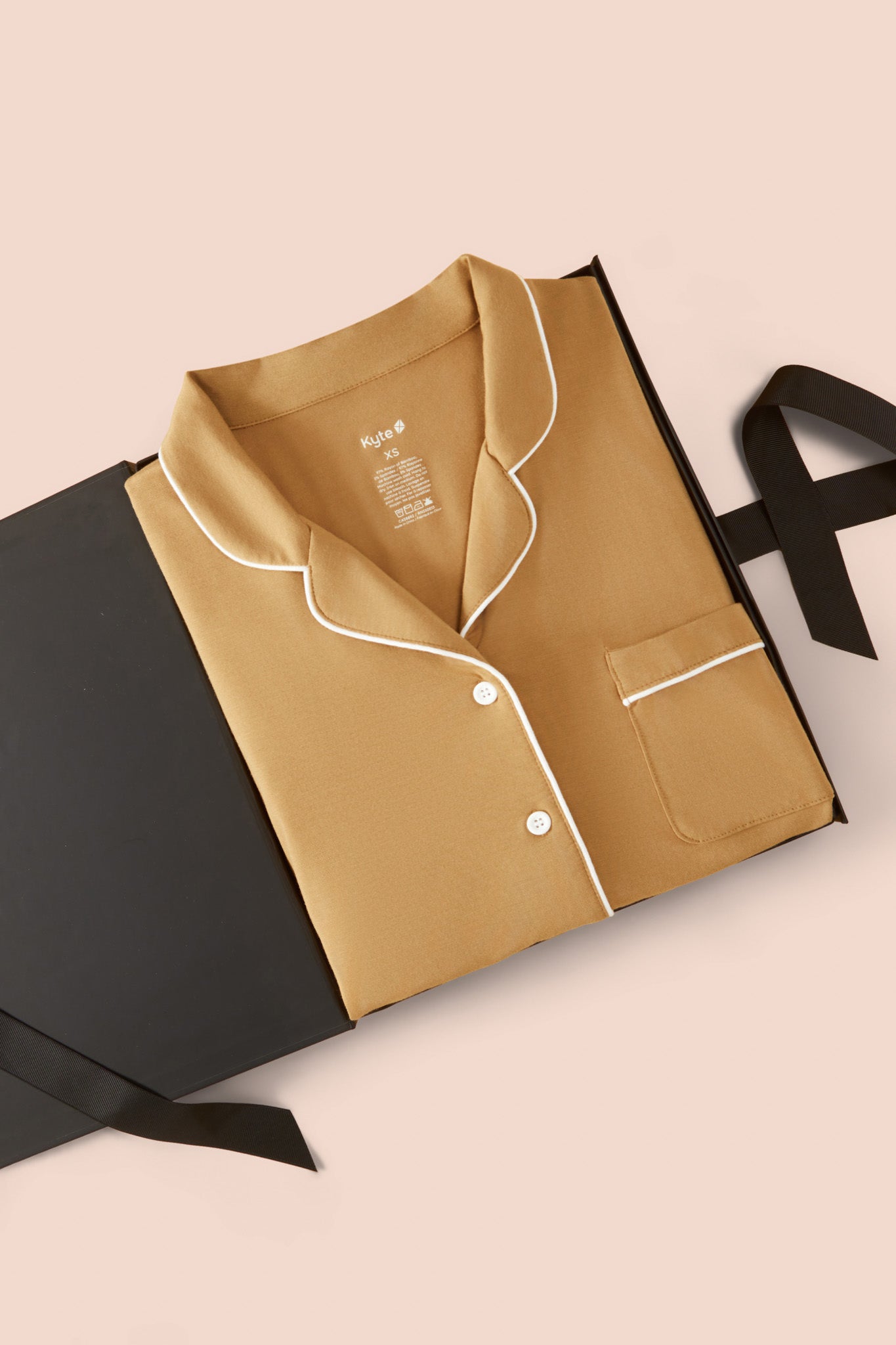 Long-Sleeved Women's Pajama Set in Ochre packed on a beige background