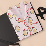 Long-Sleeved Women's Pajama Set in Princess Holiday Portraits print packed in a box on a beige background