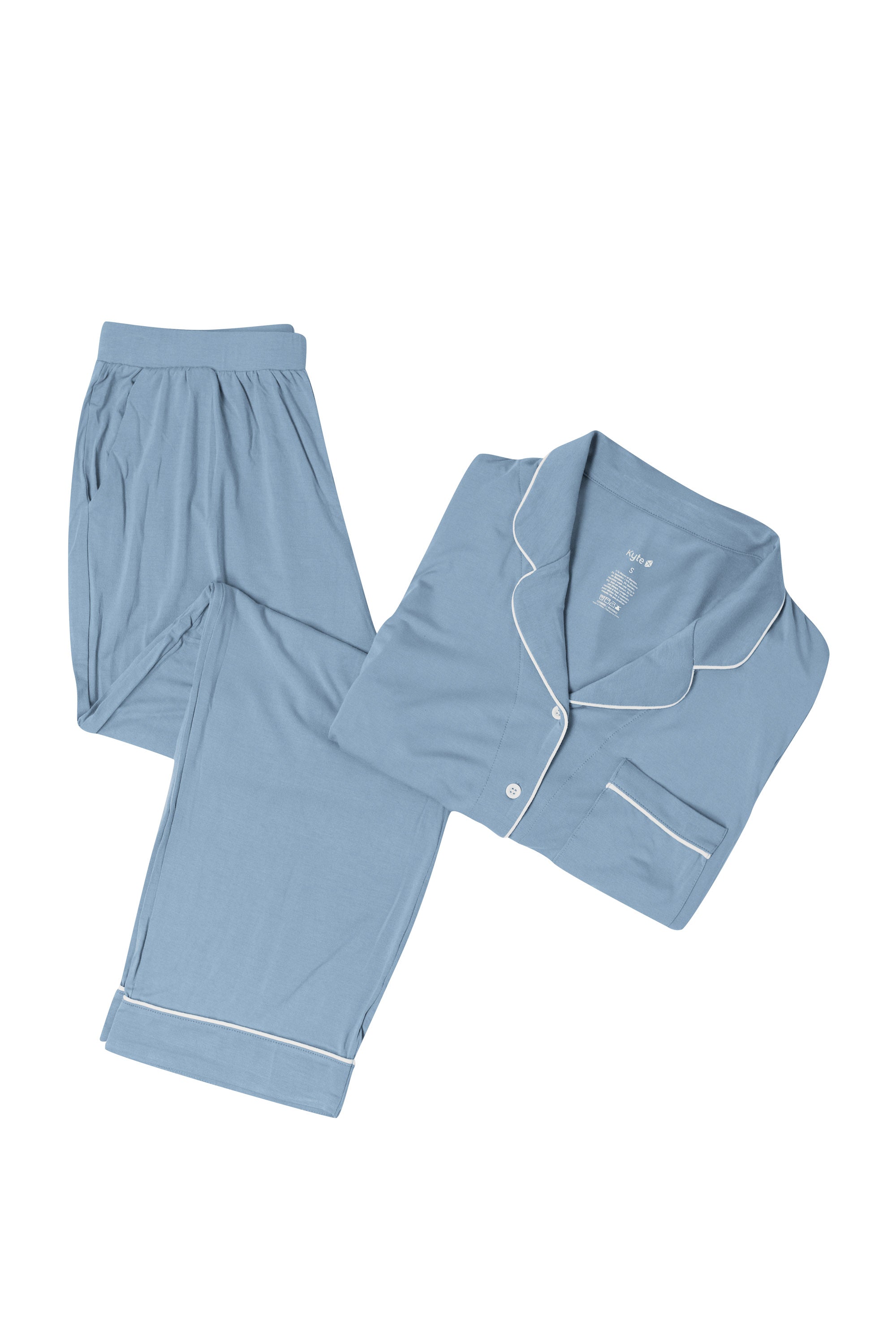 Slate blue pajama set with white piping on a white backdrop