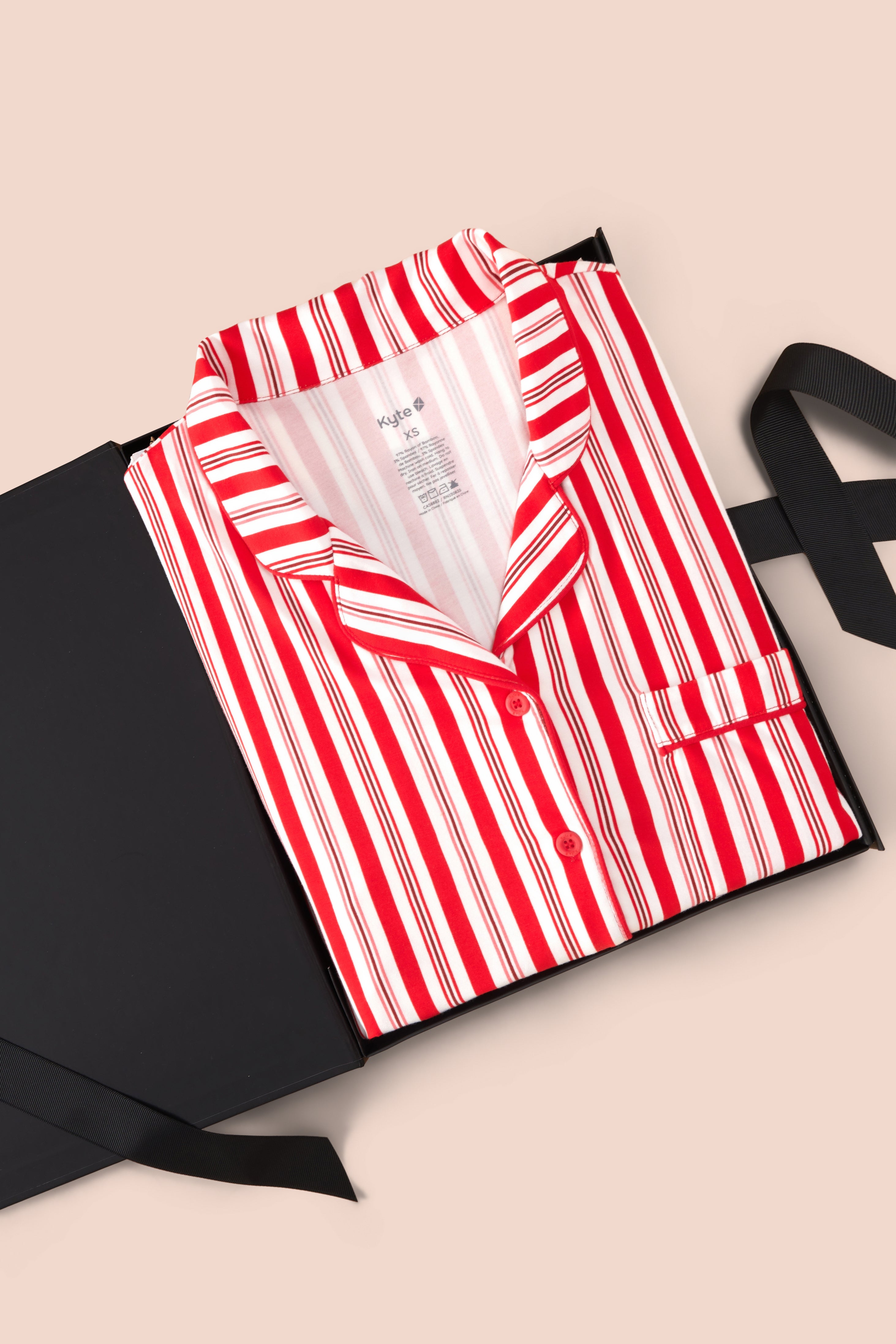 Long-Sleeved Women's Pajama Set in red and white Peppermint Stripes print packed in a box on a beige background