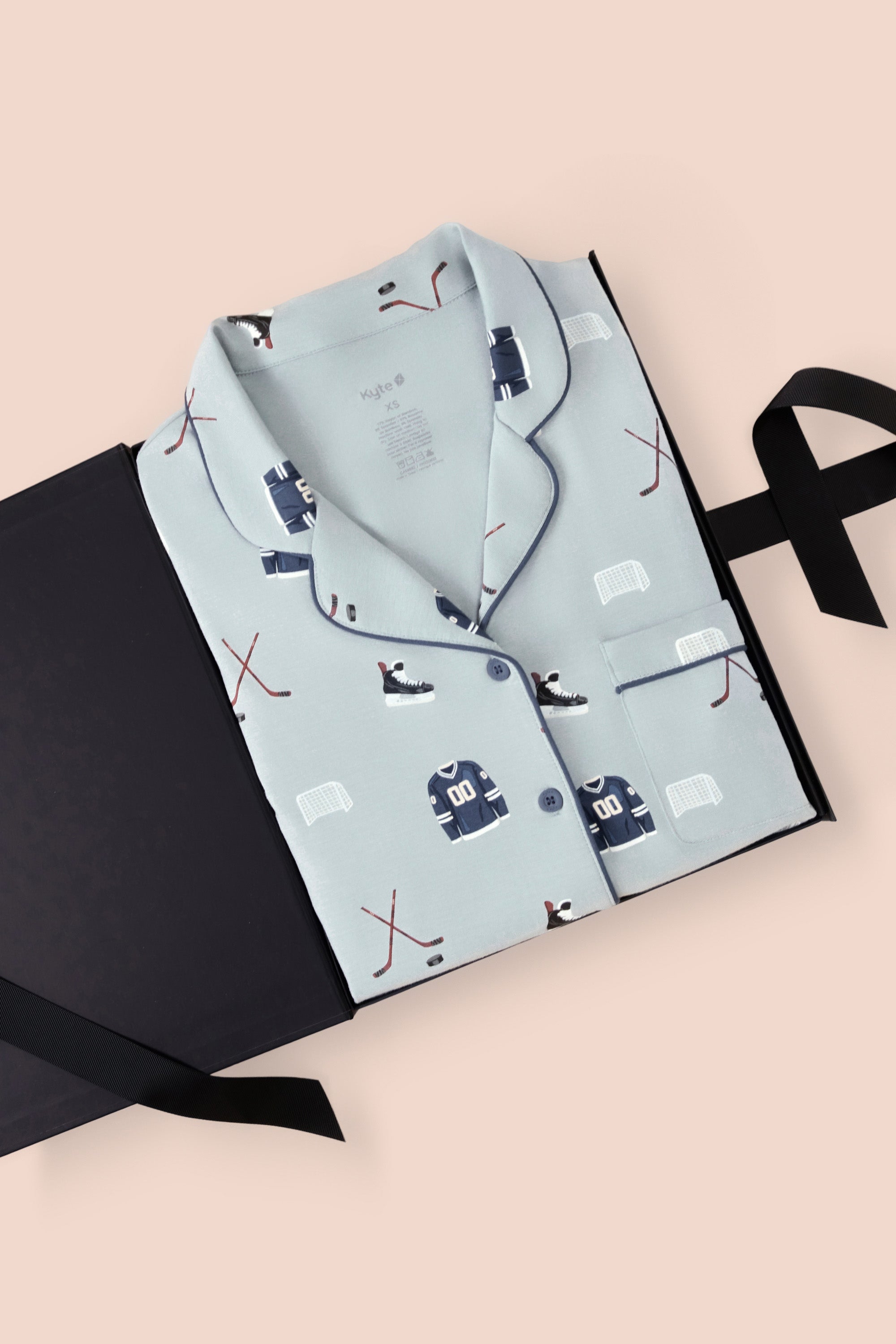Long-Sleeved Women's Pajama Set in Vintage Hockey print packed in a box on a beige background