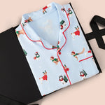 Men's Long Sleeve Pajama Set in Holiday Pups print packed in a box on  a beige background