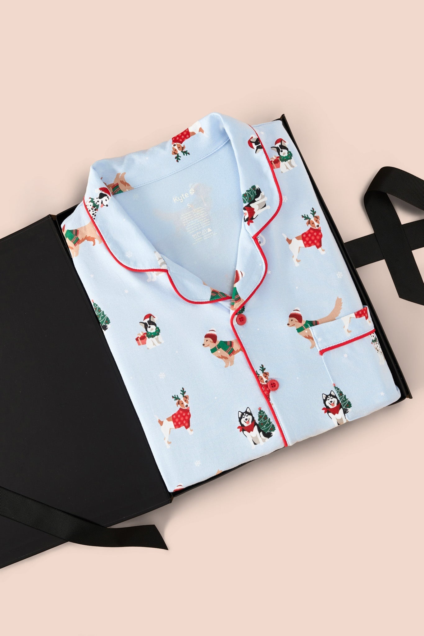 Men's Long Sleeve Pajama Set in Holiday Pups print packed in a box on  a beige background