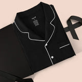 Men's Long Sleeve Pajama Set in Midnight packed in a box on a beige background