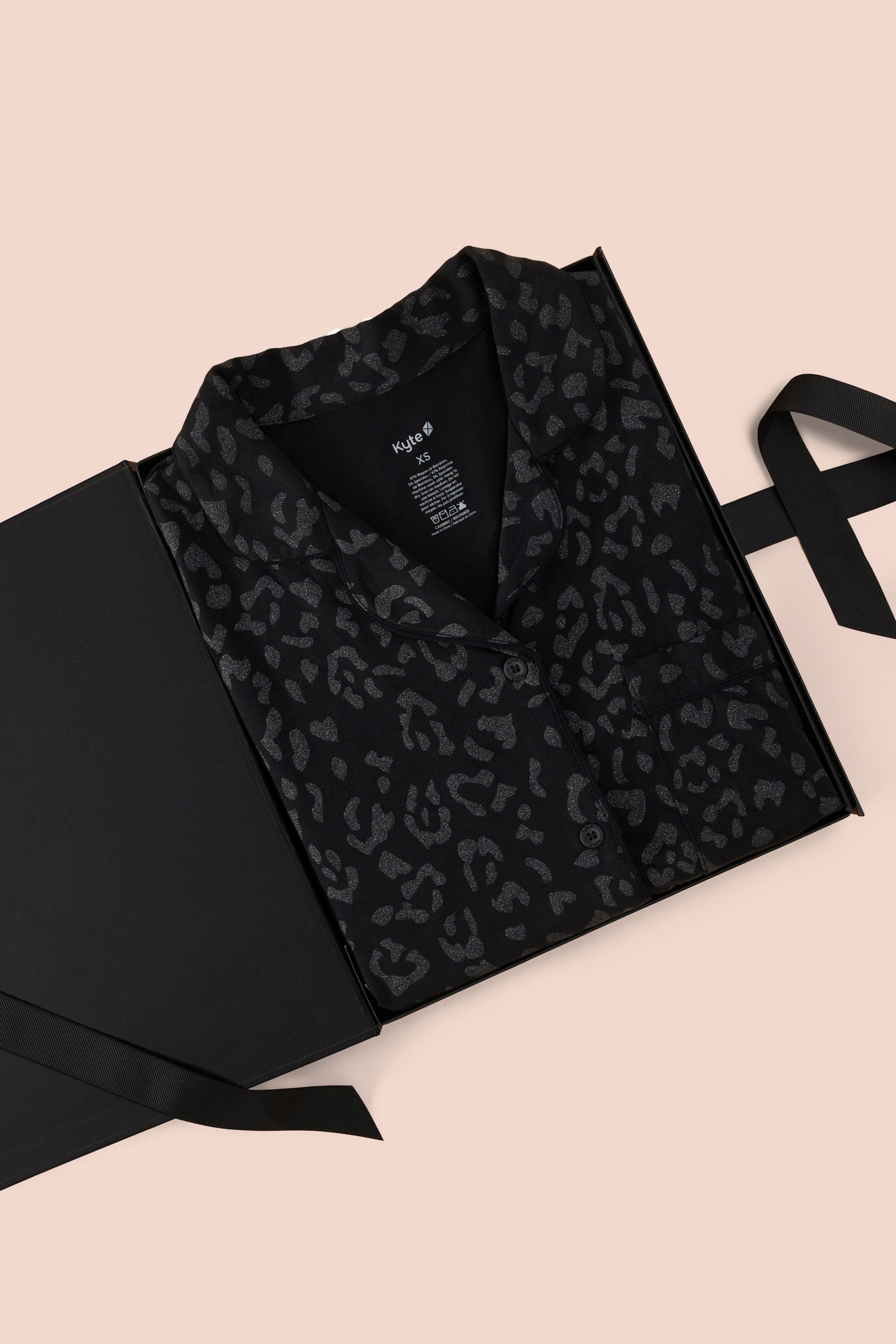 Women’s Short Sleeve Pajama Set in Midnight Leopard packed in a box on a beige background