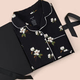 Women’s Short Sleeve Pajama Set in Big Midnight Magnolia packed in a box on a beige background