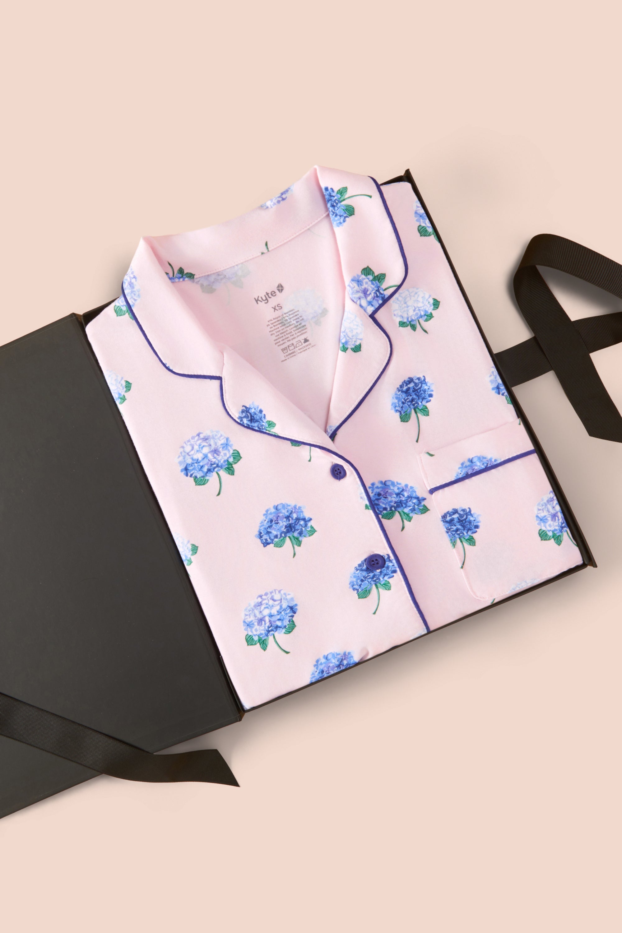 Women's Short Sleeve Pajama Set in Sakura Hydrangea packed in a box on a beige background