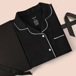Women’s Short Sleeve Pajama Set in Midnight with Cloud Trim packed in a box on a beige background