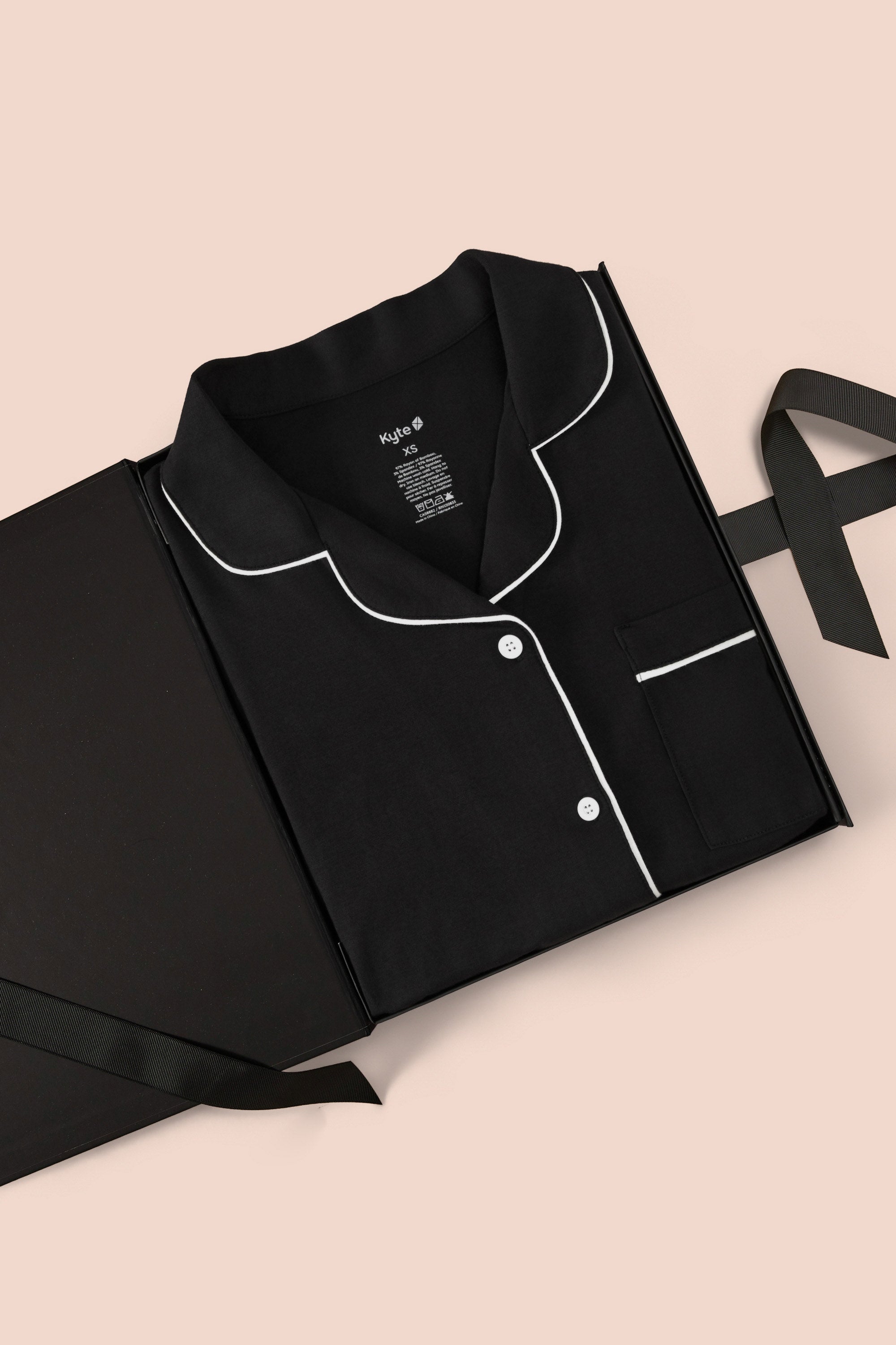 Women’s Short Sleeve Pajama Set in Midnight with Cloud Trim packed in a box on a beige background