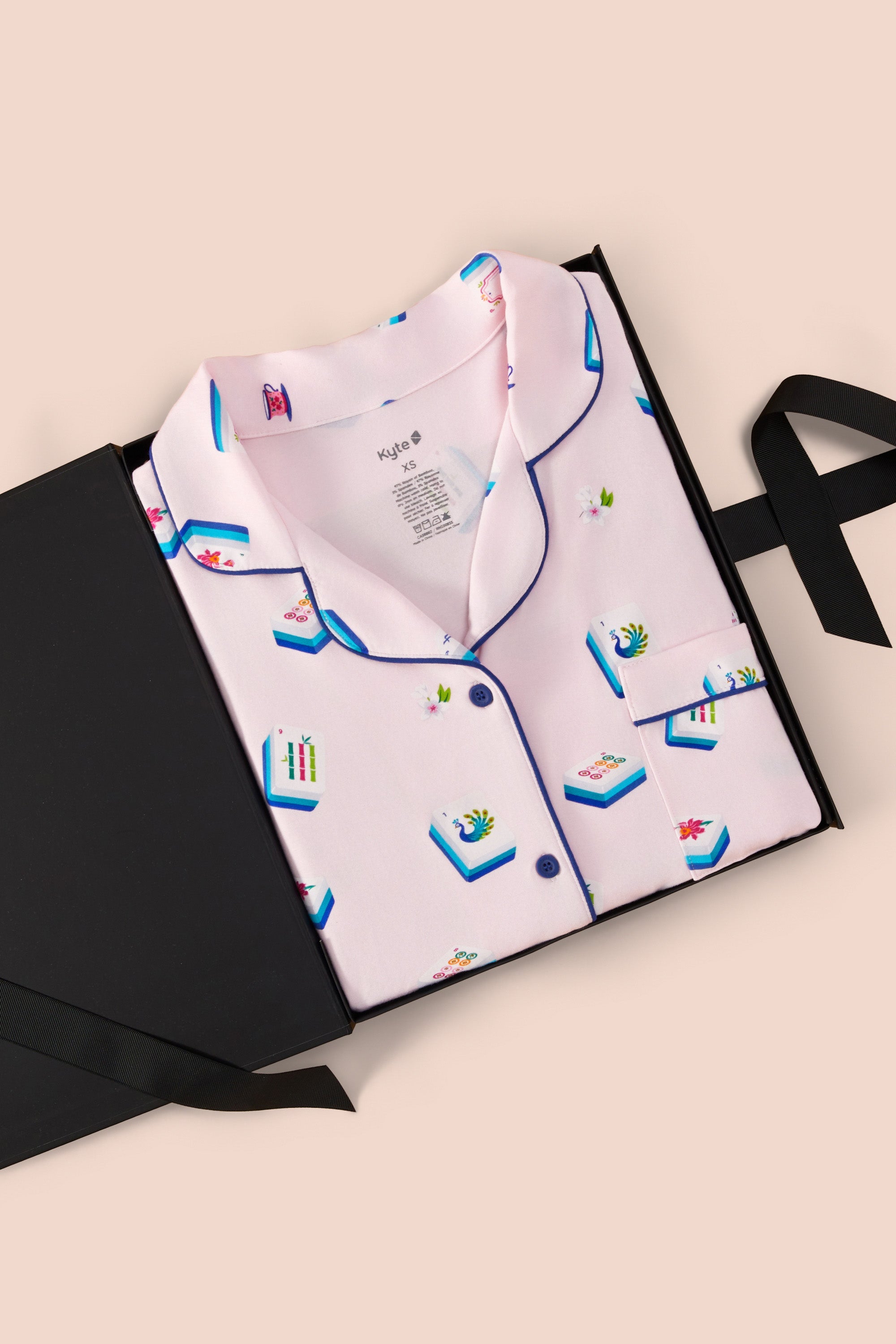 Long-Sleeved Women's Pajama Set in Sakura Mahjong print packed in a box on a beige background
