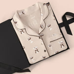 Long-Sleeved Women's Pajama Set in Espresso Martini print packed in a box on a beige background