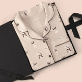 Long-Sleeved Women's Pajama Set in Espresso Martini print packed in a box on a beige background