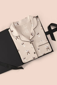 Long-Sleeved Women's Pajama Set in Espresso Martini print packed in a box on a beige background