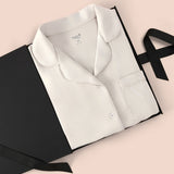 Women’s Short Sleeve Pajama Set in Oat packed in a box on a beige background