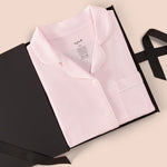 Women’s Short Sleeve Pajama Set in Sakura with Cloud Trim packed in a box on a beige background