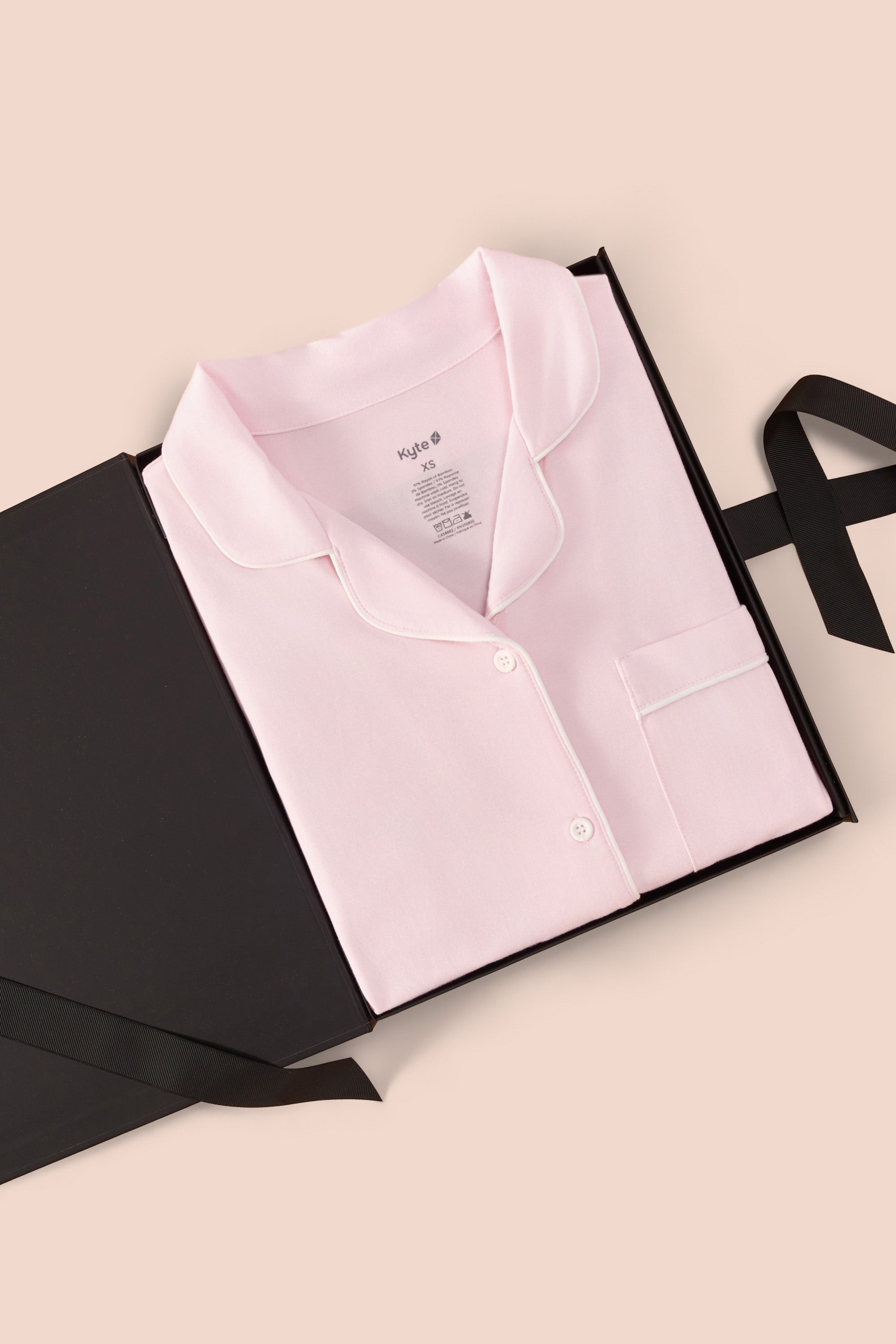 Women’s Short Sleeve Pajama Set in Sakura with Cloud Trim packed in a box on a beige background