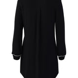 Black dress with white trim on a white background