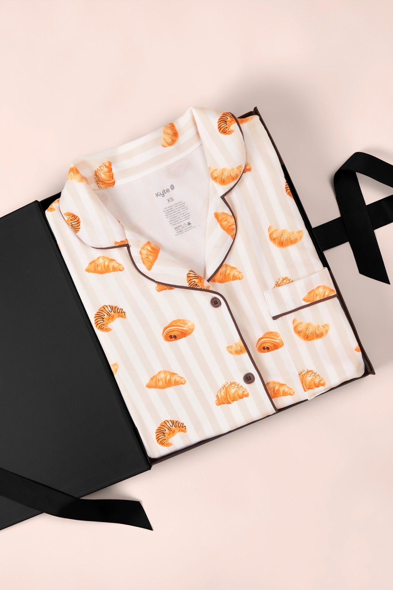 Women's Short Sleeve Cropped Pajama Set in Croissant print packed in a box on a white background