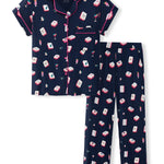 A two-piece women's pajama set featuring a short-sleeve button-front top and matching long pants in navy blue with a repeating pattern of red, white, and pink cocktail glasses and mahjong tiles, finished with pink piping.