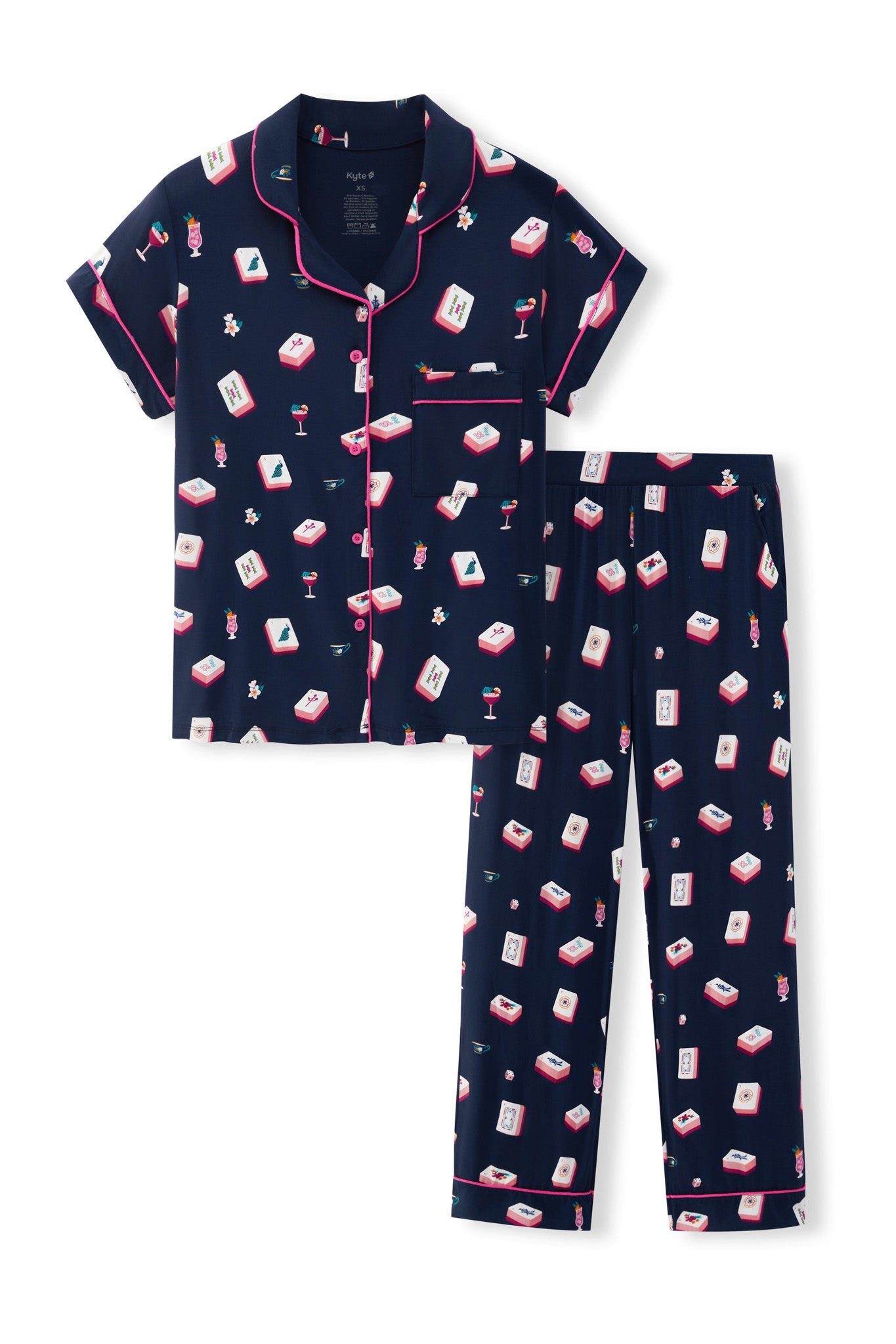 A two-piece women's pajama set featuring a short-sleeve button-front top and matching long pants in navy blue with a repeating pattern of red, white, and pink cocktail glasses and mahjong tiles, finished with pink piping.