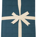 Product photo of the Kyte Bamboo Throw Blanket in Atlantic 2.5 while wrapped in an ivory bow