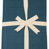 Product photo of the Kyte Bamboo Throw Blanket in Atlantic 2.5 while wrapped in an ivory bow