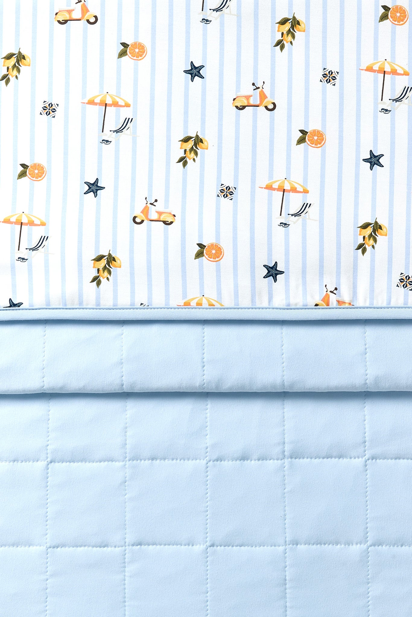 Folded Throw blanket in Amalfi Coast with printed and quilted sides showing 