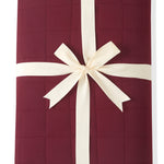 Youth Blanket in Burgundy 2.5 wrapped in a ribbon bow on a white background