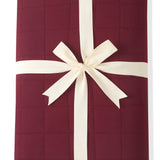 Youth Blanket in Burgundy 2.5 wrapped in a ribbon bow on a white background