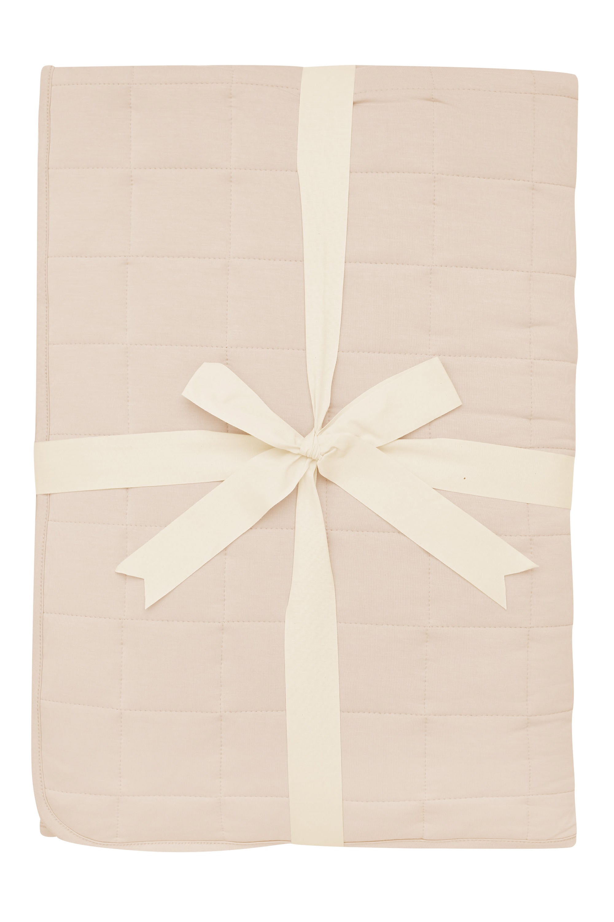 Product photo of the Kyte Bamboo Throw Blanket in Bisque 2.5 while wrapped in an ivory bow