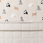 Close up of the Throw Blanket in Fluffy Cat 1.0 showing the quilted light beige backing and smooth top cat print layer