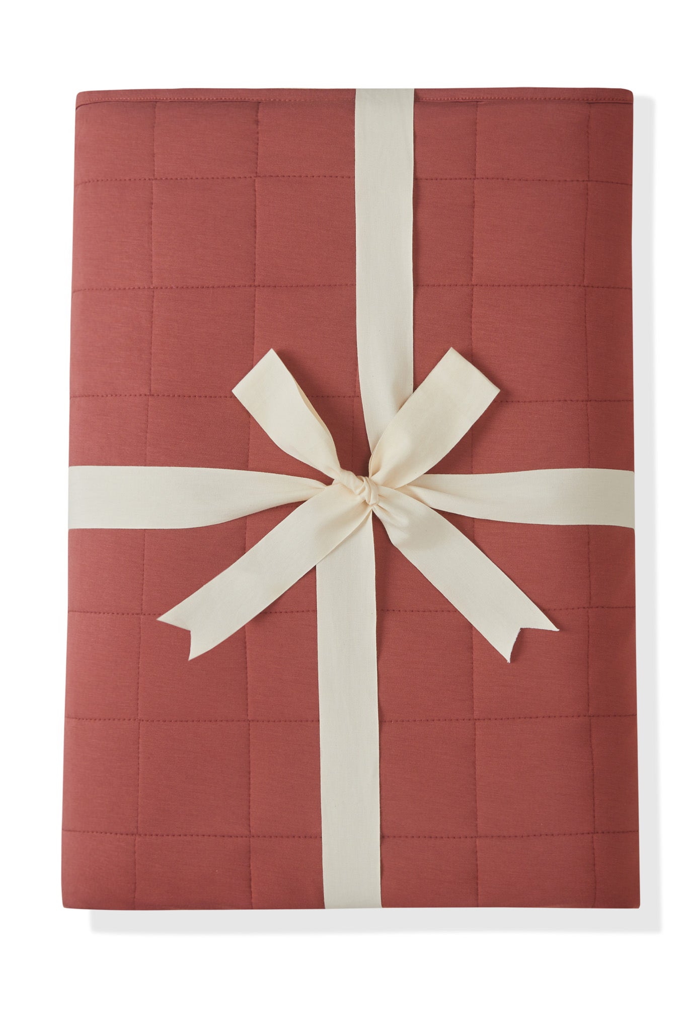 Youth Blanket in Ember 2.5 wrapped in a ribbon bow on a white background