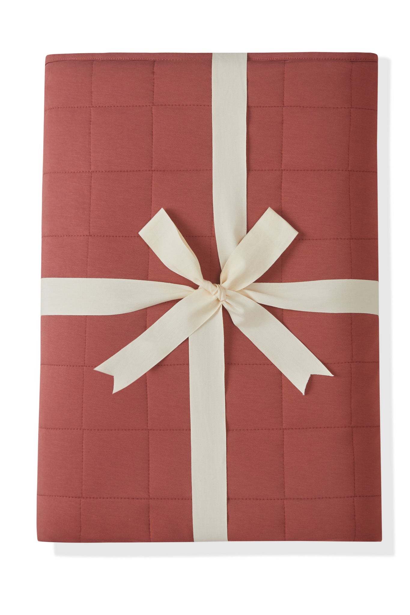 Youth Blanket in Ember 2.5 wrapped in a ribbon bow on a white background