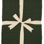 Product photo of the Kyte Bamboo Throw Blanket in Fir 2.5 while wrapped in an ivory bow