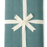 Youth Blanket in Pine 2.5 wrapped in a ribbon bow on a white background