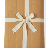 Youth Blanket in Ochre 2.5 wrapped in a ribbon bow on a white background