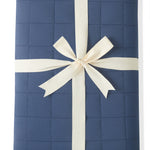 Youth Blanket in Oxford 2.5 wrapped in a ribbon bow on a white background