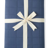 Youth Blanket in Oxford 2.5 wrapped in a ribbon bow on a white background