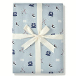 Throw Blanket in Vintage Hockey 2.5 print packed in a ribbon on a white background
