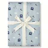 Throw Blanket in Vintage Hockey 2.5 print packed in a ribbon on a white background
