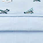 Close up of Bamboo Throw Blanket in Take Off 1.0 showing both quilted backing and printed side