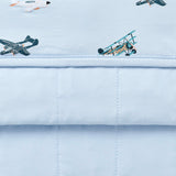 Close up of Bamboo Throw Blanket in Take Off 1.0 showing both quilted backing and printed side