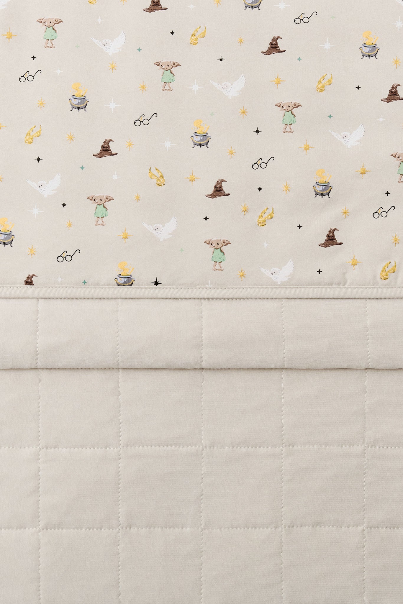 Throw Blanket in Starry Icon 1.0 folded showcasing the printed side and quilted side