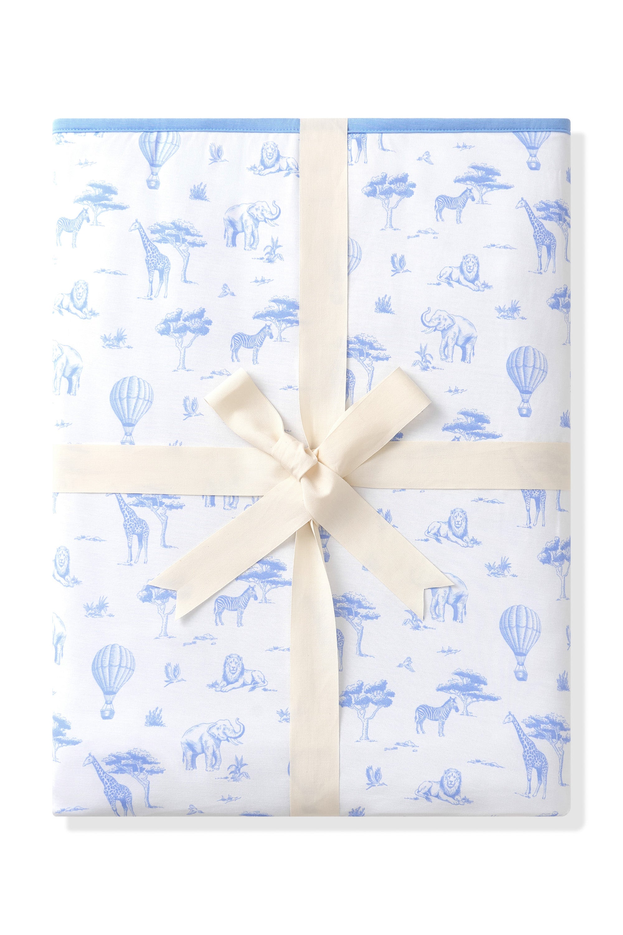Folded up Bamboo Throw Blanket in Toile Safari 1.0 wrapped in an ivory bow