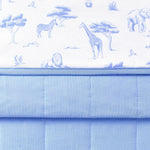 Close up of folded Bamboo Throw Blanket in Toile Safari 1.0 showcasing the printed and quilted side