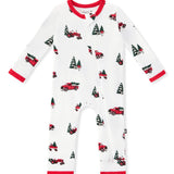 A zippered romper in white, featuring a repeating pattern of red pickup trucks carrying Christmas trees and red trim on the collar, cuffs, and ankles shown on a white background