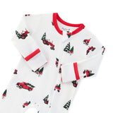 A white long-sleeve zippered footie with a red collar and cuffs, featuring an all-over print of red pickup trucks carrying Christmas trees displayed on a white background