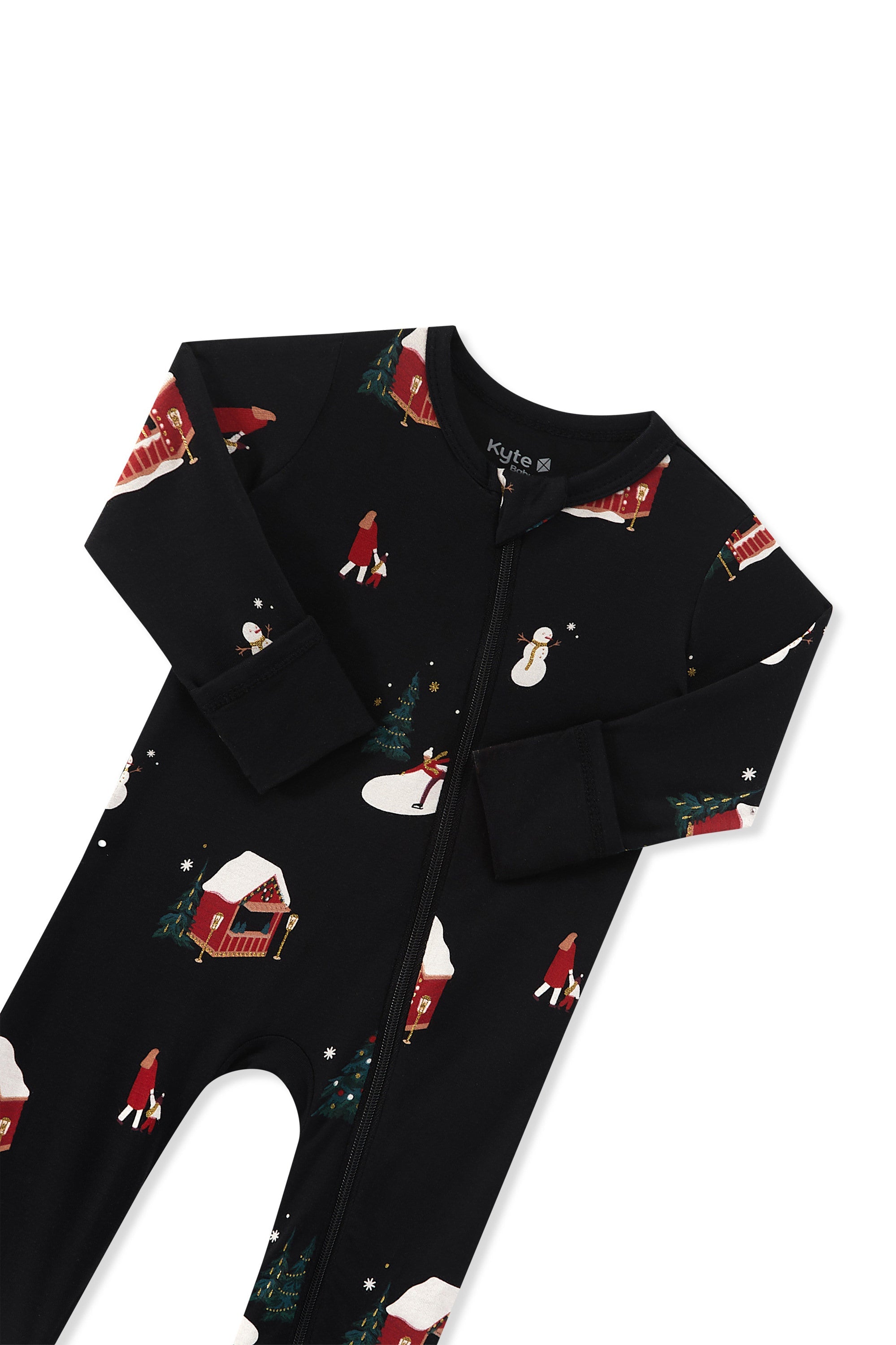 A black zippered romper with a festive Christmas print featuring snowmen, snow-covered cabins, and Santa Claus, with zipper garage displayed flat against a white background.