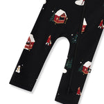 Bottom part of Black zippered romper with a festive Christmas winter wonderland print featuring snow-covered cabins, snowmen, and trees, shown on a white background.