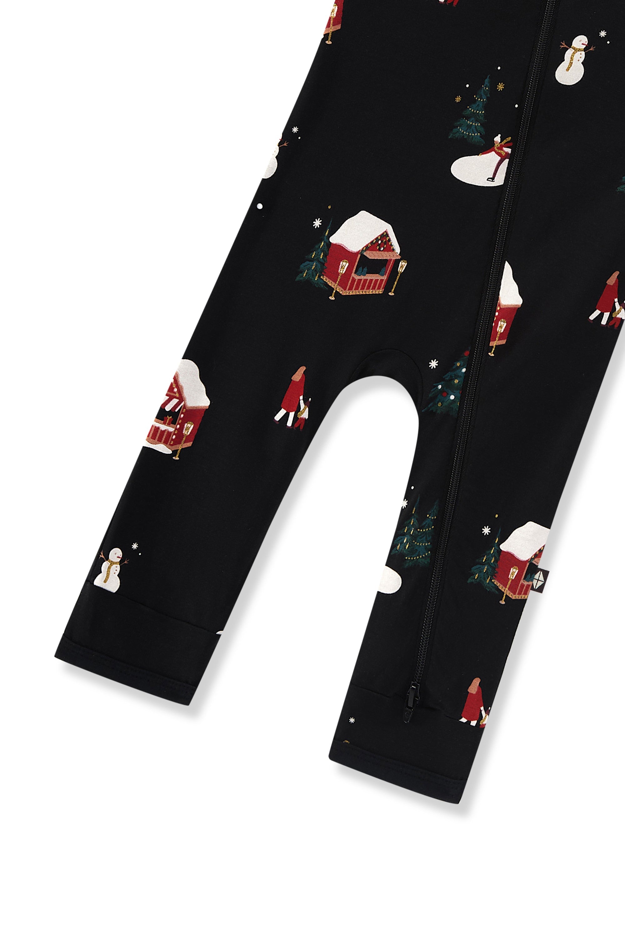 Bottom part of Black zippered romper with a festive Christmas winter wonderland print featuring snow-covered cabins, snowmen, and trees, shown on a white background.